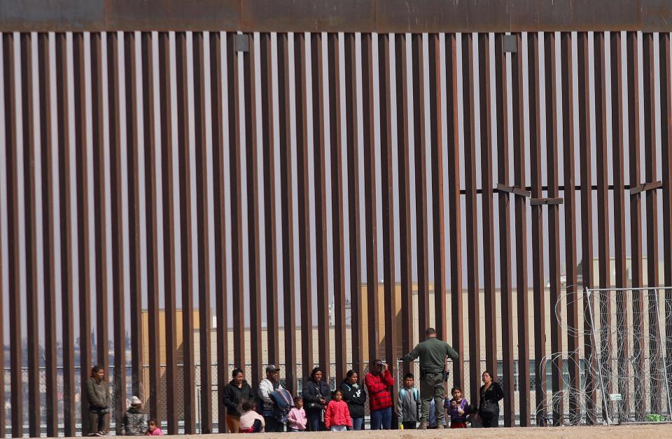 Texas National Guard agents process migrants on February 29, 2024. US President Joe Biden and former President Donald Trump both visited the US-Mexico border in Texas today, in Brownsville and Eagle Pass, respectively. (Photo by Herika Martinez / AFP)