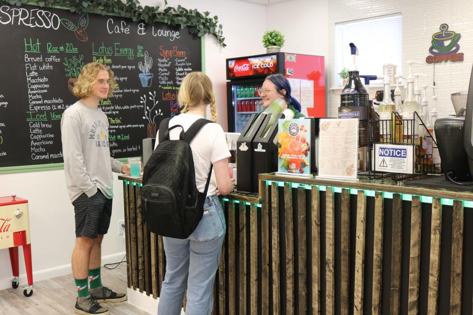 From left, Gabriel Walsingham and Izzy Connors place their orders with Emily Connors at the recently opened Techspresso Lounge & Cafe in Panama City Beach on Monday.