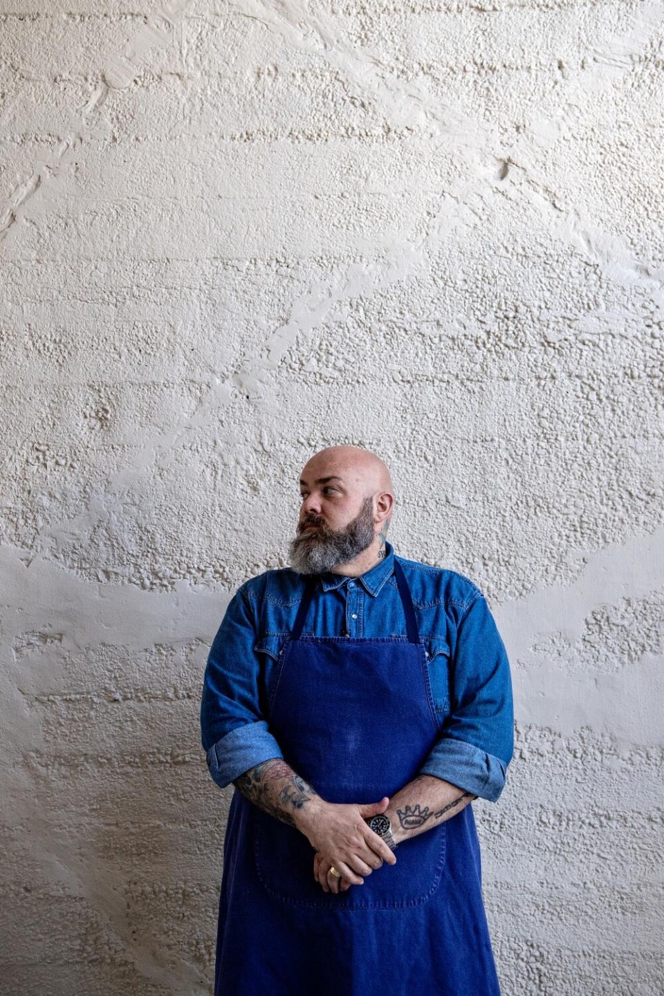 Chef Evan Funke in a denim shirt and blue apron.