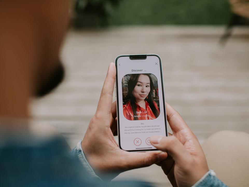 Man looking at woman's dating profile