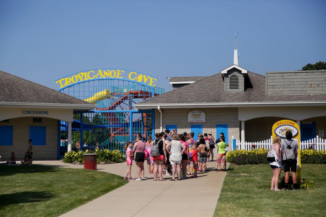 A line forms outside the entrance to Tropicanoe Cove before they opened, Friday, June 28, 2019 at Columbian Park in Lafayette.