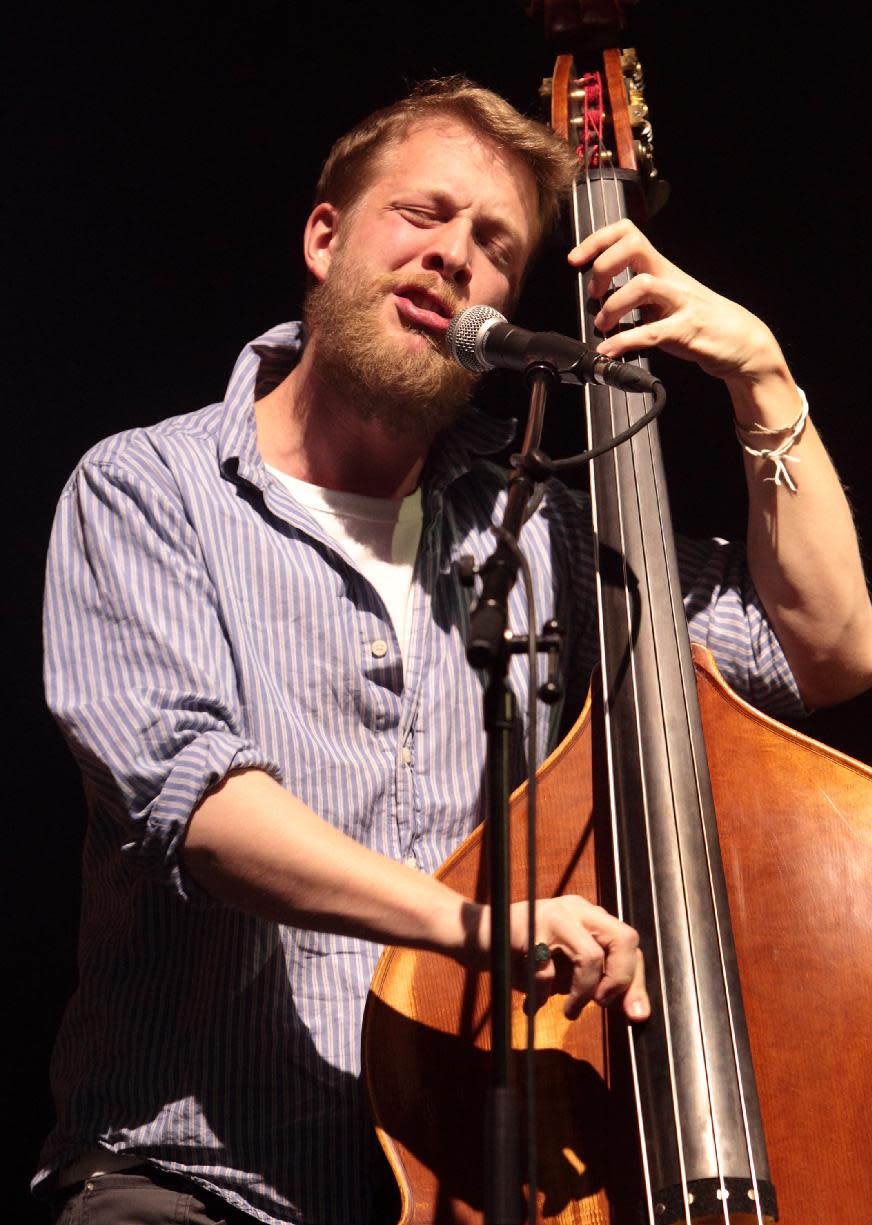 FILE - In this Feb. 16, 2013 file photo, Ted Dwane, of the English folk rock band Mumford & Sons, performs at the Susquehanna Bank Center in Camden, N.J. Mumford & Sons on Thursday, June 13, 2013 announced it has canceled its headlining performance at Bonnaroo Music & Arts Festival in Tennessee. The decision comes after Dwane received treatment this week for a blood clot on his brain. (Photo by Owen Sweeney/Invision/AP, file)