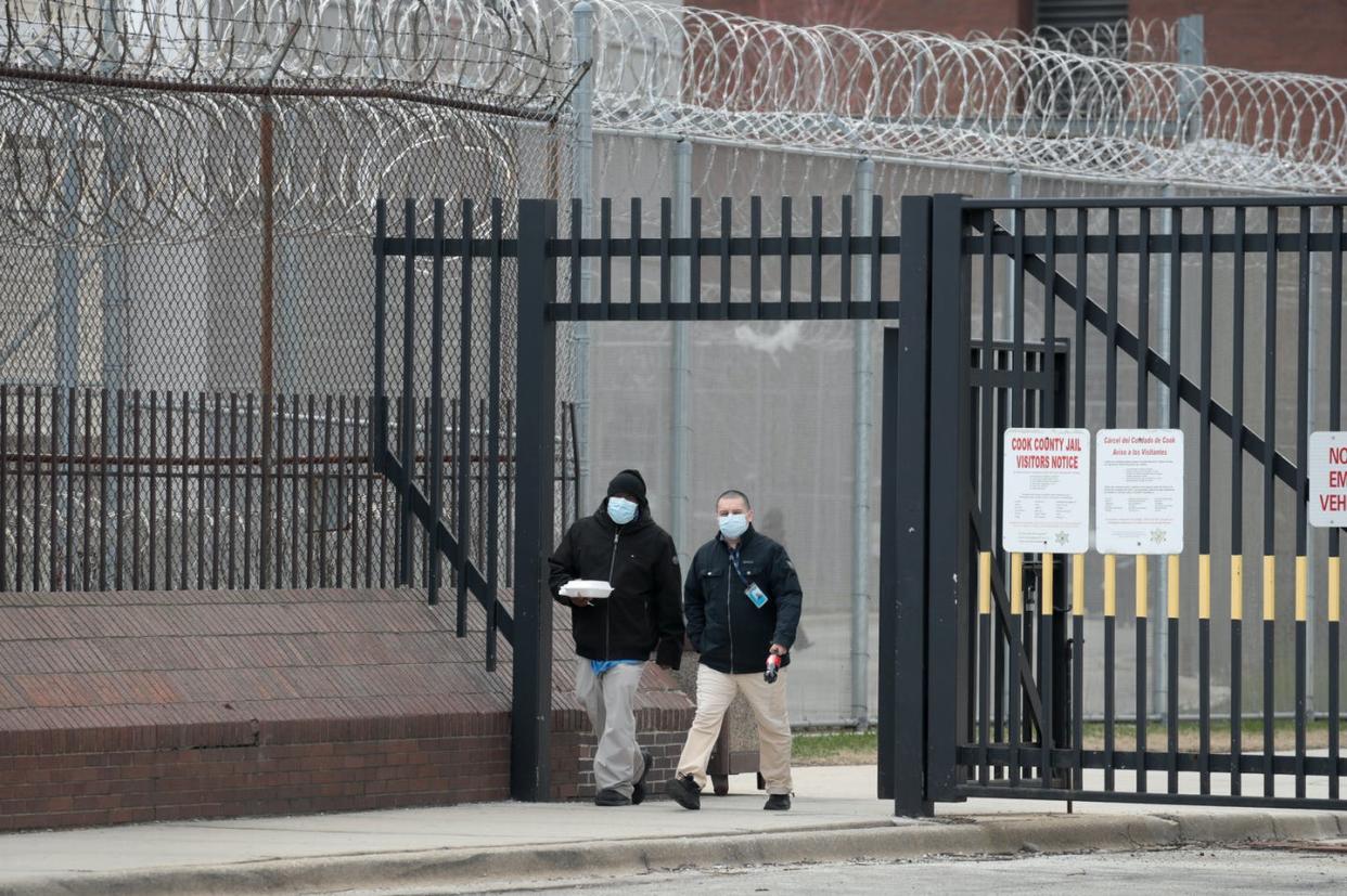 <span class="caption">While prison may isolate people from the larger community, it does not isolate them from COVID-19.</span> <span class="attribution"><a class="link " href="https://www.gettyimages.com/detail/news-photo/people-wearing-protective-masks-leave-the-cook-county-jail-news-photo/1217875901" rel="nofollow noopener" target="_blank" data-ylk="slk:Scott Olson/Staff/Getty Images News;elm:context_link;itc:0;sec:content-canvas">Scott Olson/Staff/Getty Images News</a></span>