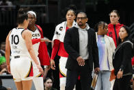 Las Vegas Aces interim head coach Tyler Marsh greets guard Kelsey Plum (10) during a timeout against the Seattle Storm during the second half of a WNBA basketball game Saturday, May 20, 2023, in Seattle. The Aces won 105-64. (AP Photo/Lindsey Wasson)