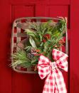 <p>Or, try the same technique but with holly, pinecones, and a red and white plaid bow so you can keep it up for the holidays ahead. </p>