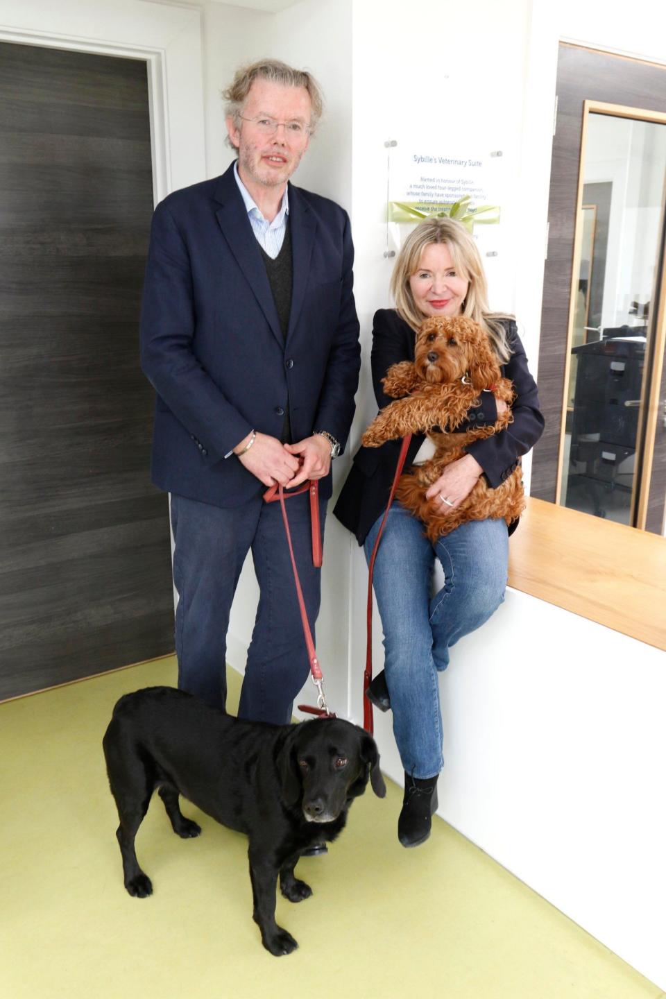 Julia and Hans Rausing with their their dogs Sybille, the black labrador, and Billy, during a visit to the RSPCA South Cotswolds Branch dogs and cats home, where they had supported the opening of a new veterinary suite