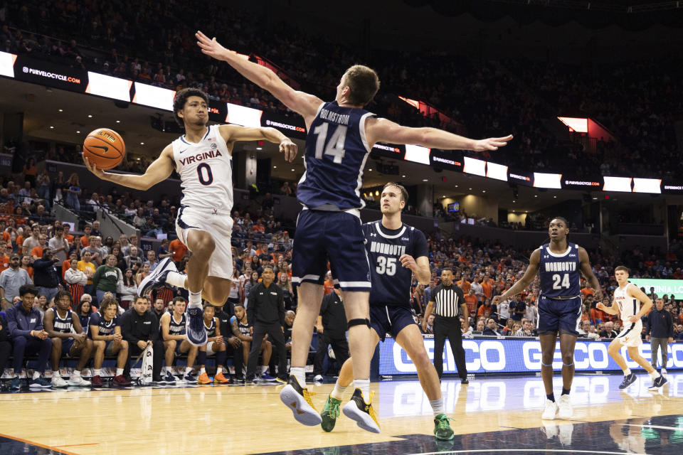 Virginia's Kihei Clark (0) passes the ball against Monmouth during the first half of an NCAA college basketball game in Charlottesville, Va., Friday, Nov. 11, 2022. (AP Photo/Mike Kropf)