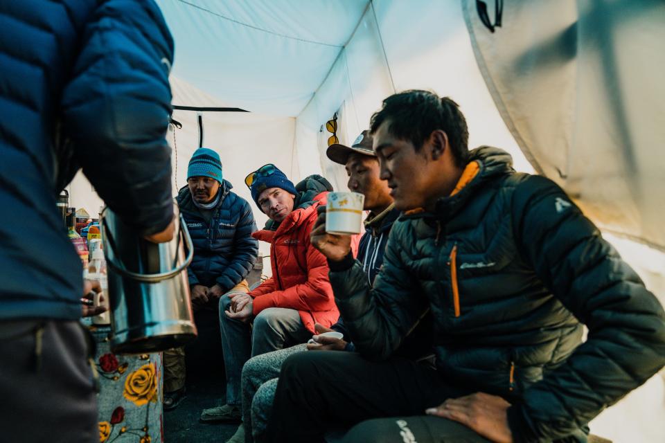 Ballinger sits with his Sherpa teammates in Makalu Advanced Base Camp discussing final plans for the summit attempt over cups of hot coffee and tea. From left to right is Dorji Sonam Sherpa, Adrian's Sherpa Sirdar (lead sherpa) and long-time climbing partner and friend. To Ballinger's right is Phu Rita Sherpa and Ngima Tenzing Sherpa.