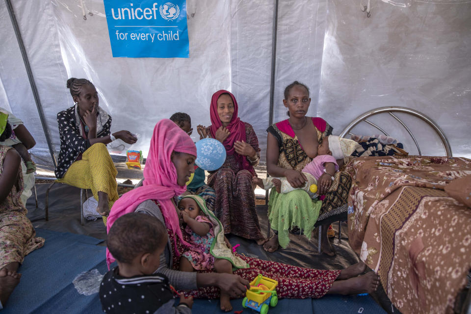 Women sit with their breastfeed their children as Filippo Grandi, U.N. High Commissioner for Refugees, visits Umm Rakouba refugee camp sheltering people who fled the conflict in Ethiopia's Tigray region in Qadarif, eastern Sudan, Saturday, Nov. 28, 2020. (AP Photo/Nariman El-Mofty)