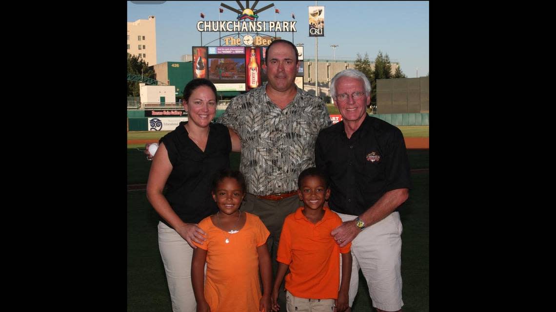 Chris Cummings (right) took a photo with former San Francisco Giants star Will Clark (center) when he visited Chukchansi Park in downtown Fresno. Cummings was joined by his then wife of 10 years Mona Nyandoro Cummings (left) and his stepchildren Tandiwe Nyandoro (inner, left) and Wesley inner, right).