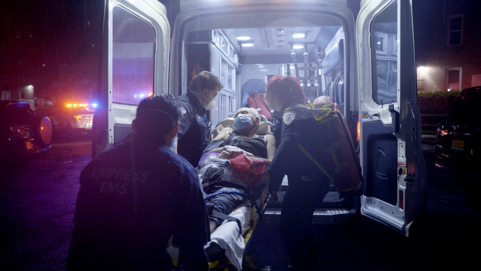 A patient is put in an ambulance by EMT's in Yonkers, N.Y., on April 30, 2020. (Ed Ou / NBC News)