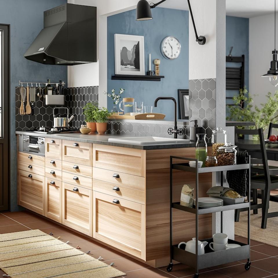 Black storage trolley in wooden designed kitchen