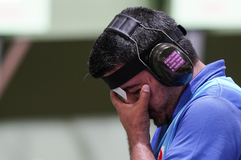 Javad Foroughi, of Iran, pauses as he competes in the men's 10-meter air pistol at the Asaka Shooting Range in the 2020 Summer Olympics, Saturday, July 24, 2021, in Tokyo, Japan. (AP Photo/Alex Brandon)