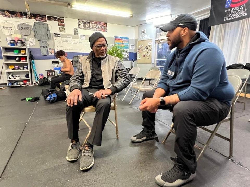 Lorenzo Scott, left, and Markees Watkins chat at United Boxing Club in Canton. Watkins, owner of United Boxing Club, will honor Scott on Saturday at The Brawl II in Canton for his work in boxing in Stark County.