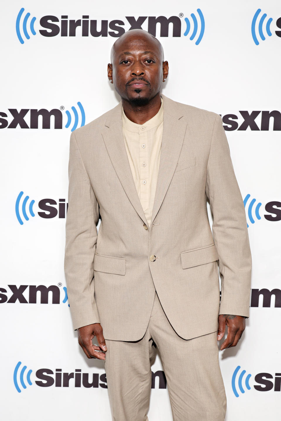 Man in a beige suit at a SiriusXM event