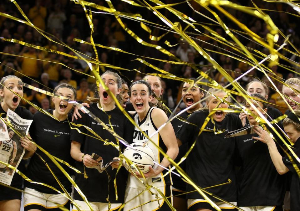 PHOTO: Guard Caitlin Clark celebrates with teammates during a presentation after breaking the NCAA women's all-time scoring record during the game against the Michigan Wolverines  at Carver-Hawkeye Arena on Feb. 15, 2024 in Iowa City, Iowa.   (Matthew Holst/Getty Images)