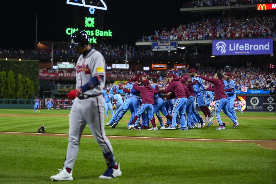 The Philadelphia Phillies celebrate after Game 4 of the NLDS. The Phillies beat the Braves to advance to the NLCS. (AP Photo/Matt Rourke)