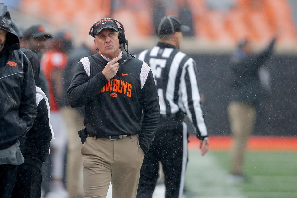 OSU coach Mike Gundy walks along the sideline during a 24-19 loss to West Virginia on Nov. 26 in Stillwater.