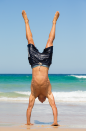 <p>One of the lifeguards does a handstand, all in the name of charity.</p>
