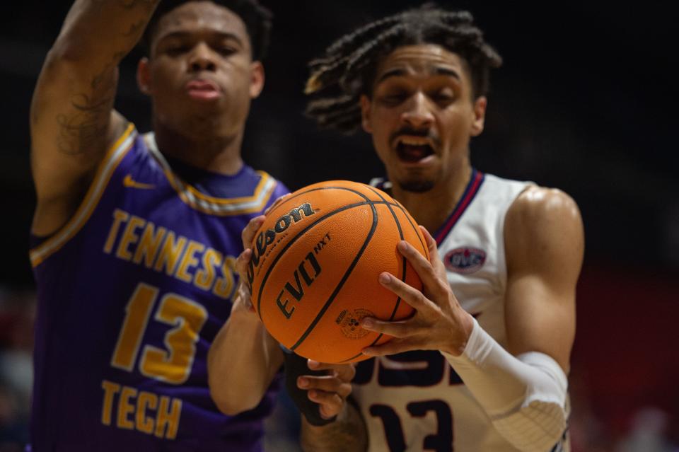 Southern Indiana’s Jeremiah Hernandez (13) and Tennessee Tech’s Jayvis Harvey (13) grab the ball simultaneously during a match at University of Southern Indiana on Thursday, Feb. 23, 2023.