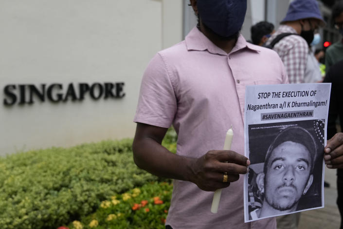 Activists attend a candlelight vigil against the impending execution of Nagaenthran K. Dharmalingam, sentenced to death for trafficking heroin into Singapore, outside the Singaporean embassy in Kuala Lumpur, Malaysia, Monday, Nov. 8, 2021. Singapore's High Court has halted the imminent execution of a Malaysian man believed to have a mental disability, amid pleas from the international community and rights groups. (AP Photo/Vincent Thian)