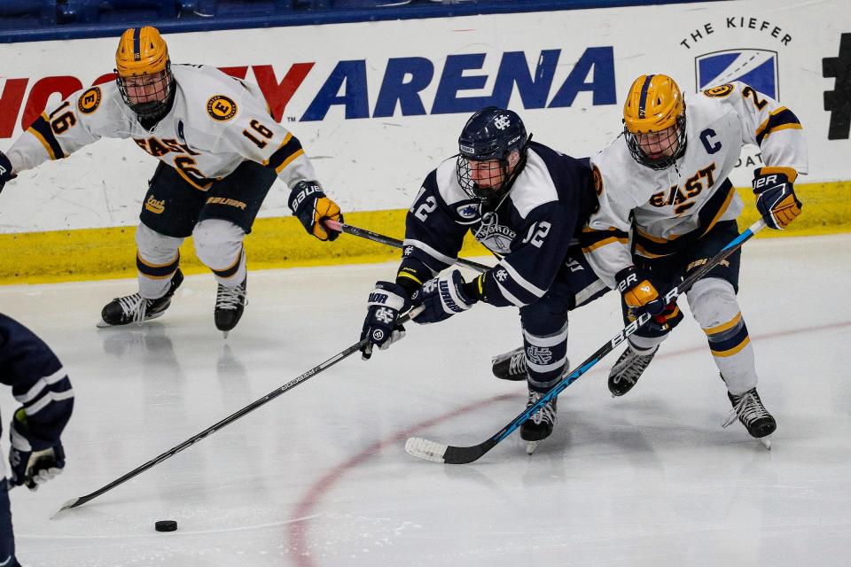 Bloomfield Hills Cranbrook Kingswood forward Nick Timko is defended by East Grand Rapids forward Ian MacKeigan during the first period of the MHSAA Division 3 hockey final at USA Hockey Arena in Plymouth on Saturday, March 9, 2024.