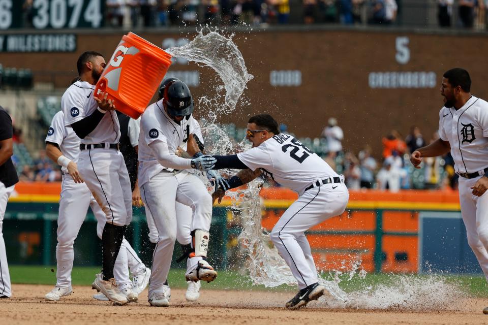 Detroit Tigers right fielder Victor Reyes (22) receives congratulations from teammates after he hits a walk off two-RBI double in the ninth inning against the San Diego Padres at Comerica Park in Detroit on Wednesday, July 27, 2022.