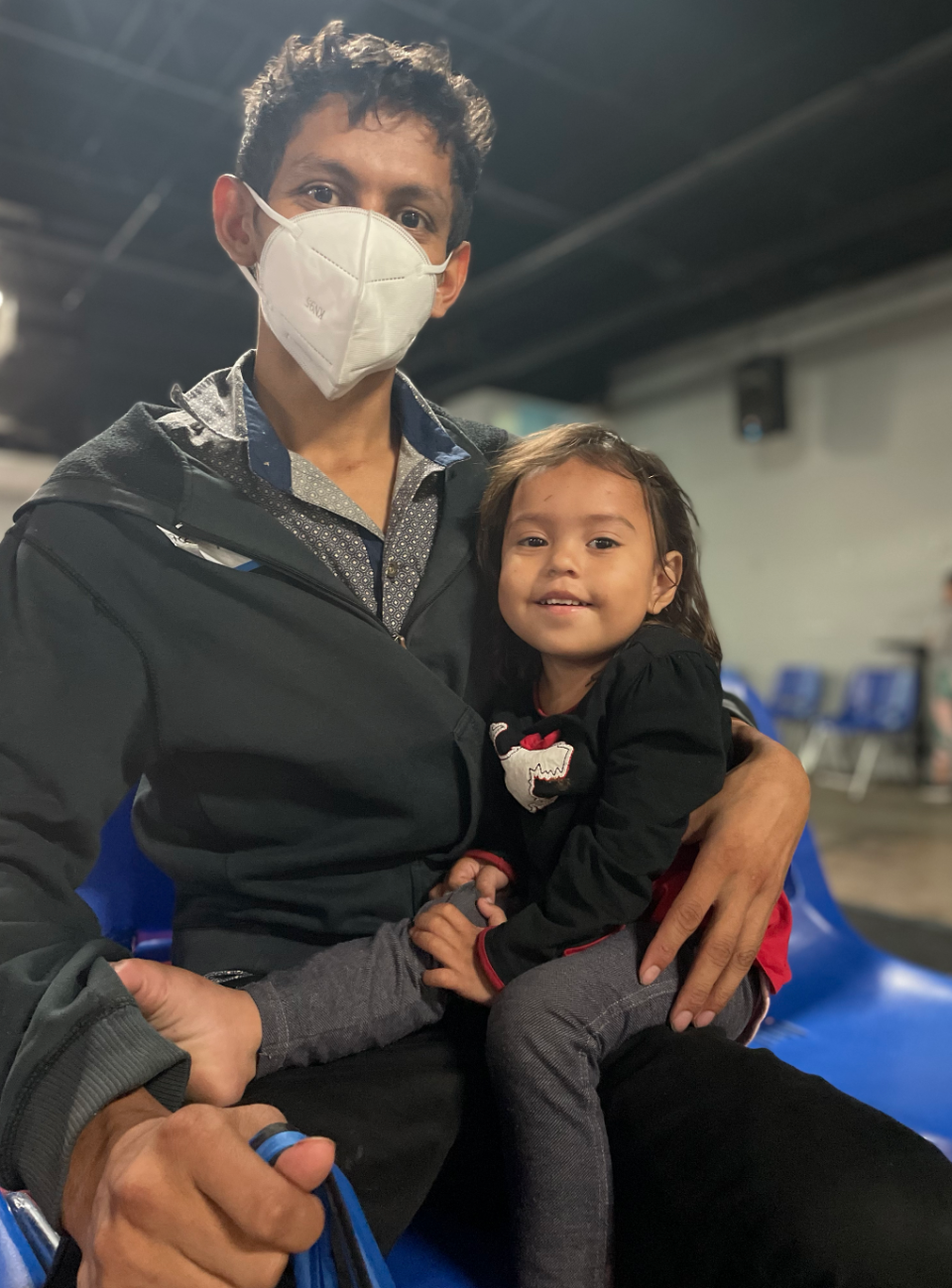 Elmer and his daughter Stacy sit at a Catholic Charities site in McAllen, Texas days after crossing into the U.S. / Credit: Natacha Larnaud