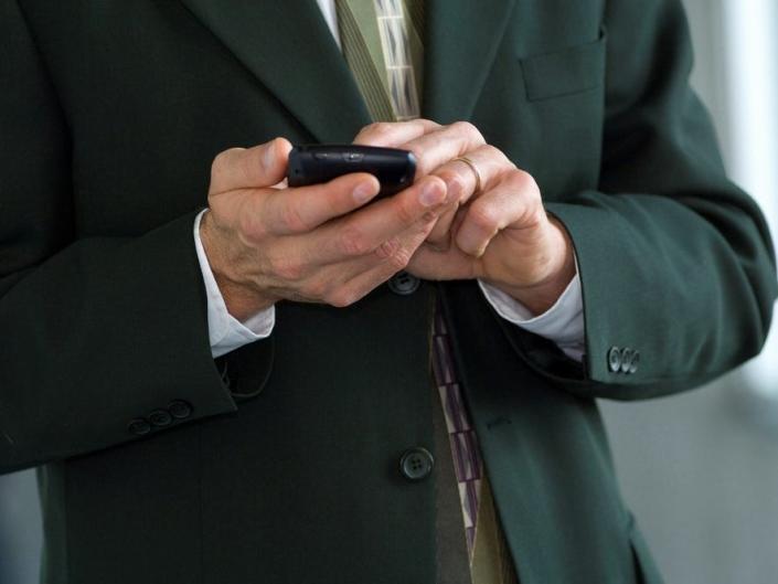 man business suit texting 