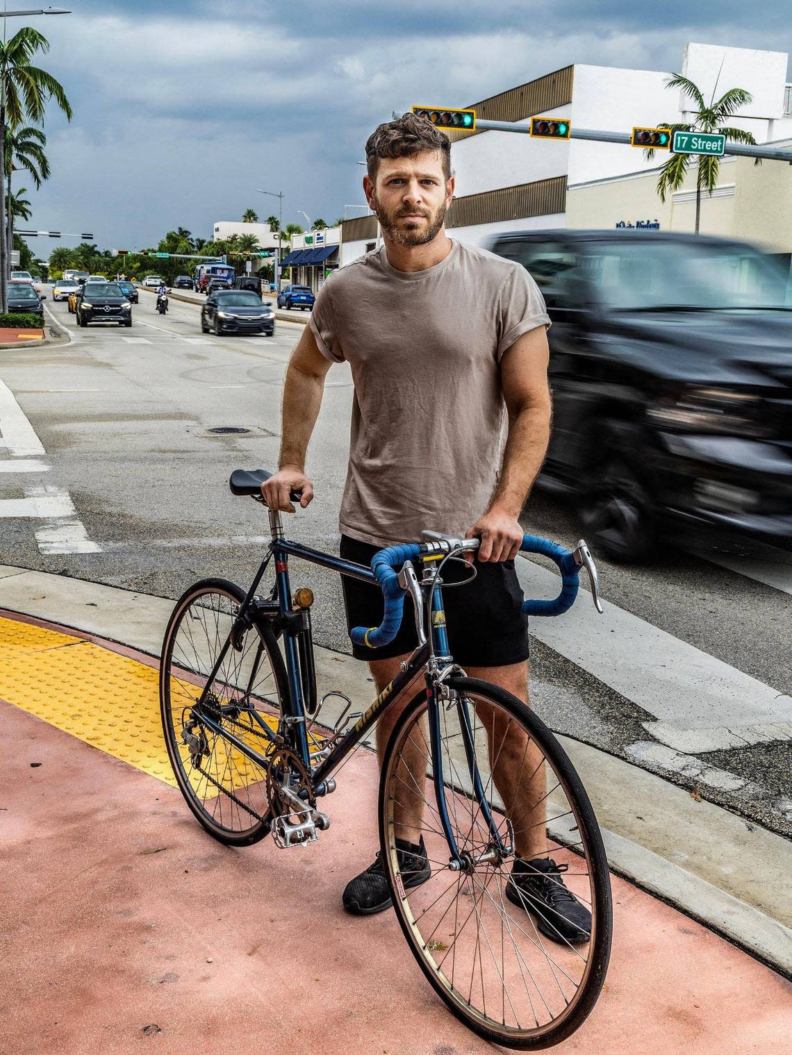 Jeremy Sapienza stands at the corner of Alton Road and 17th Street in Miami Beach, where he was involved in a road rage incident as he biked in the street near his house, on July 7, 2023.