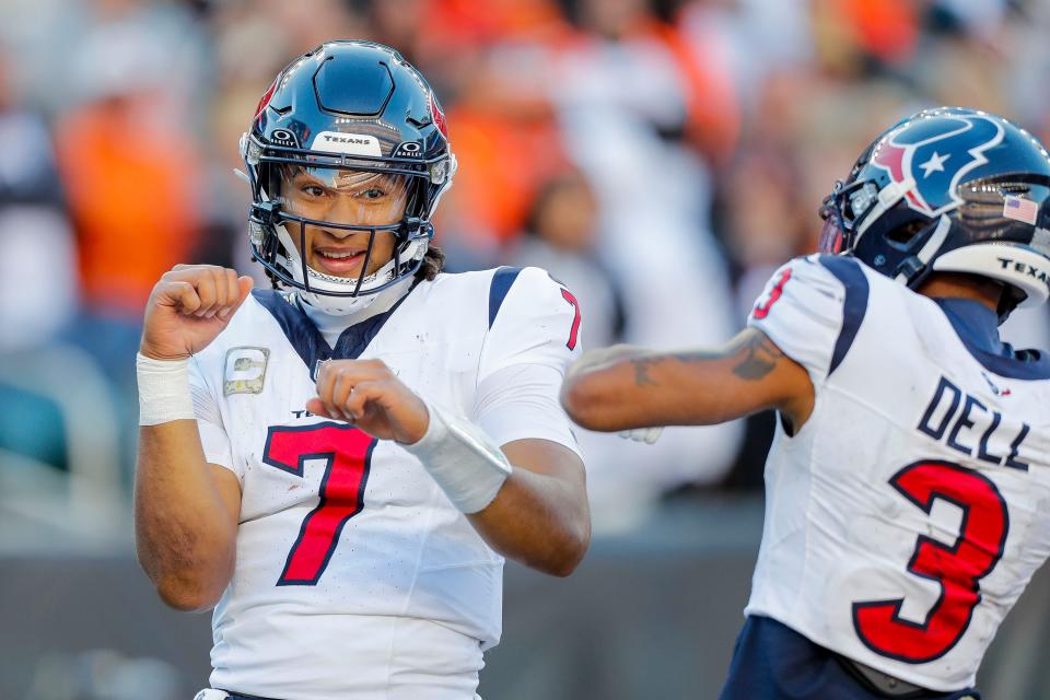 Houston Texans quarterback C.J. Stroud (7) reacts after scoring a touchdown with wide receiver Tank Dell (3) in the second half against the Cincinnati Bengals at Paycor Stadium.