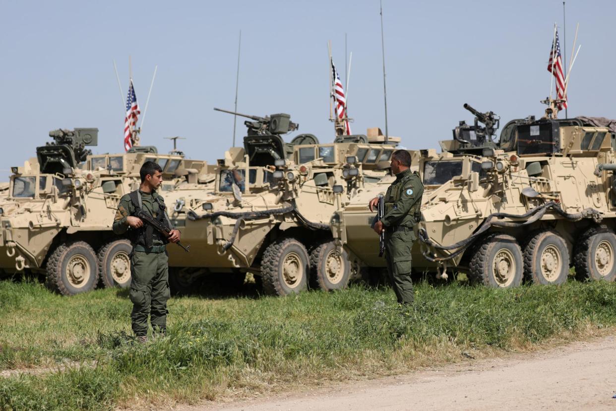 Kurdish YPG fighters stand near US military vehicles in the town of Darbasiya near the Turkish border, in Syria on 29 April 2017: REUTERS