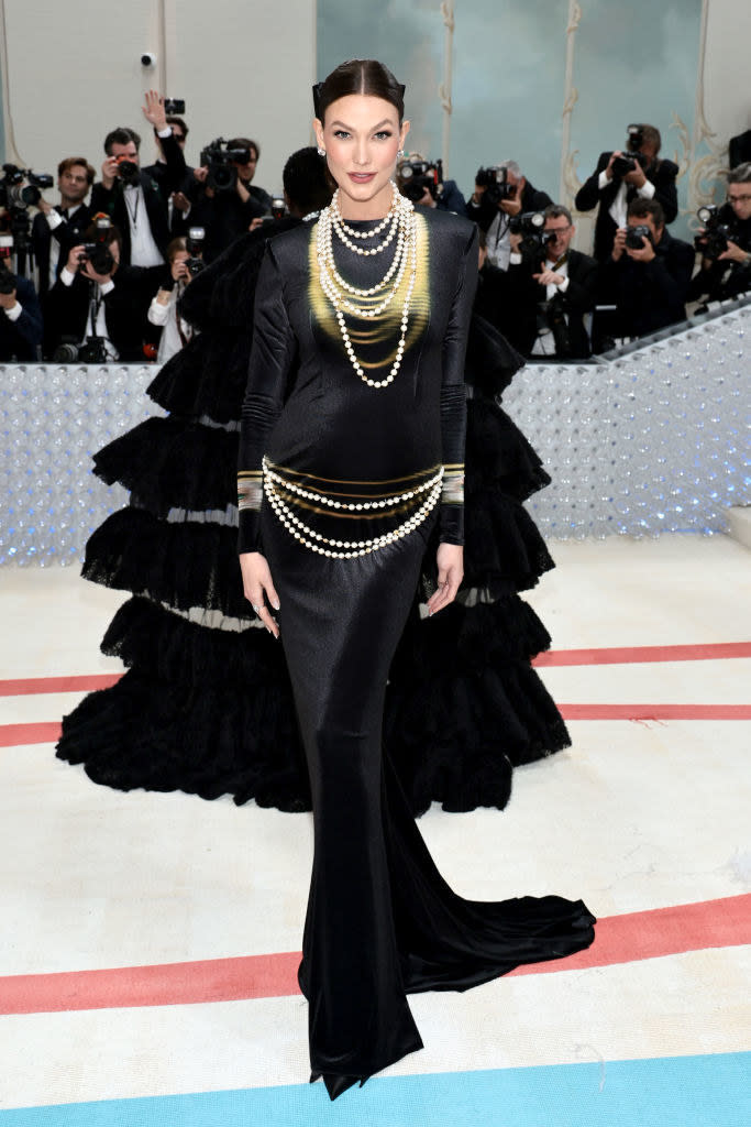 Karlie Kloss attends The 2023 Met Gala in a black gown