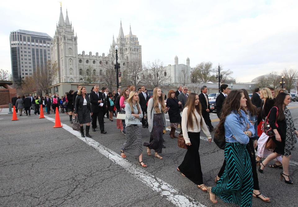 People walk pass the Salt Lake Temple on the way to the Conference Center during opening session of the two-day Mormon church conference Saturday, April 5, 2014, in Salt Lake City. More than 100,000 Latter-day Saints are expected in Salt Lake City this weekend for the church's biannual general conference. Leaders of The Church of Jesus Christ of Latter-day Saints give carefully crafted speeches aimed at providing members with guidance and inspiration in five sessions that span Saturday and Sunday. (AP Photo/Rick Bowmer)
