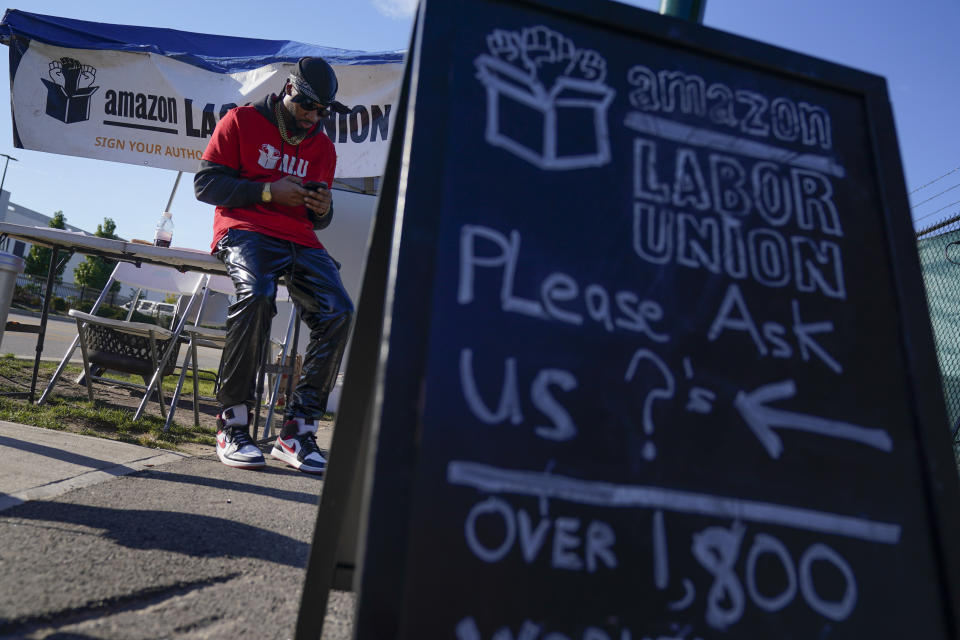 Chris Smalls, president of the Amazon Labor Union, sets up an information booth to collect signatures across the street from an Amazon distribution center in the Staten Island borough of New York, Thursday, Oct. 21, 2021. A bid to unionize Amazon workers at the distribution center in New York City neared an important milestone, as organizers prepared to deliver hundreds of signatures to the National Labor Relations Board as soon as Monday for authorization to hold a vote. (AP Photo/Seth Wenig)