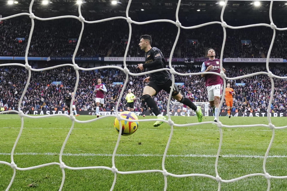 Arsenal's Gabriel Martinelli, centre, scores his side's fourth goal during the English Premier League soccer match between Aston Villa and Arsenal at Villa Park in Birmingham, England, Saturday, Feb. 18, 2023. (AP Photo/Jon Super)