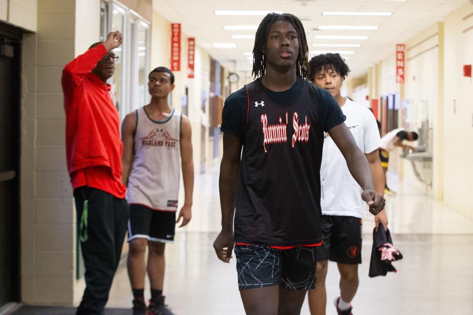 Highland Park junior Ja’Corey Robinson walks with teammates toward the south gymnasium to practice Feb. 6. Robinson said playing most of the team's games away this season hasn't affected him much as he thrives in the competitive environment.