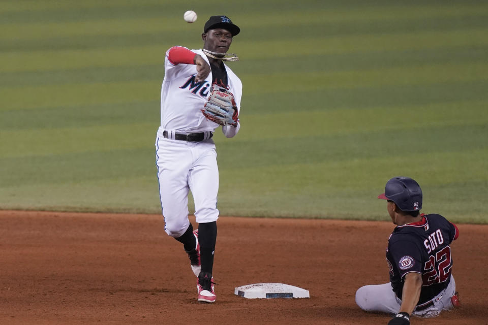 Washington Nationals' Juan Soto (22) is out on second base as Miami Marlins second baseman Jazz Chisholm Jr. throws to first to complete the double play during the fifth inning of a baseball game, Wednesday, Sept. 22, 2021, in Miami. (AP Photo/Marta Lavandier)