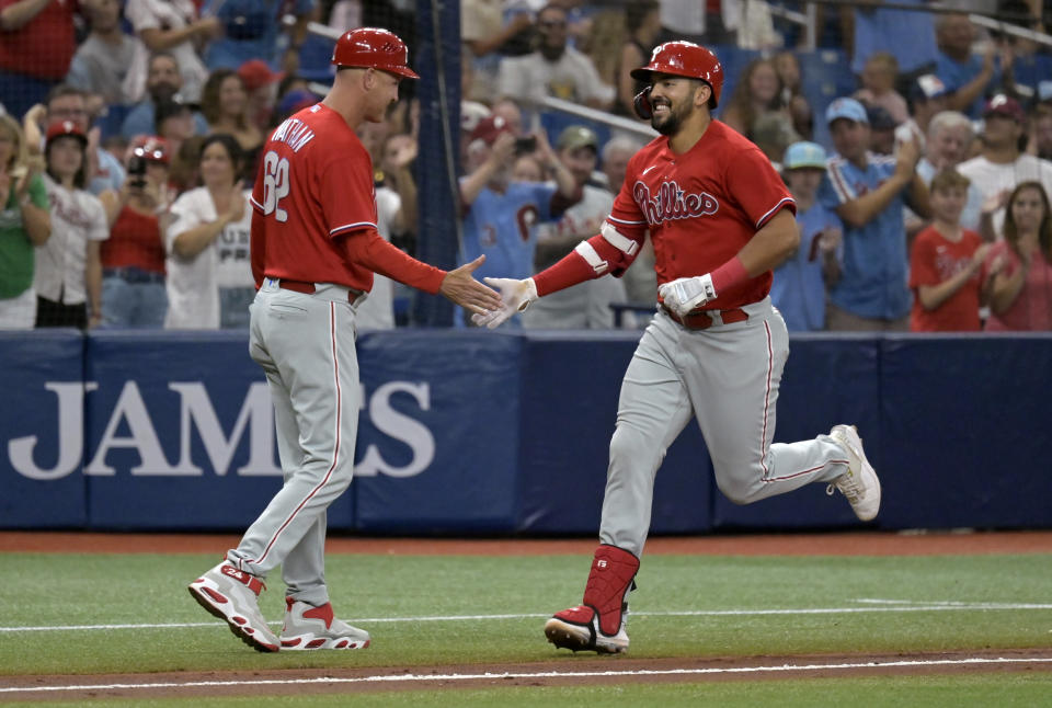 Philadelphia Phillies third base coach Dusty Wathan, left, congratulates Darick Hall after Hall's solo home run off Tampa Bay Rays reliever Jake Diekman during the fifth inning of a baseball game Thursday, July 6, 2023, in St. Petersburg, Fla. (AP Photo/Steve Nesius)