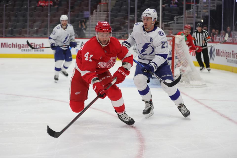Red Wings center Luke Glendening goes after the puck against Lightning defenseman Ryan McDonagh during the first period on Sunday, May 2, 2021, at Little Caesars Arena.