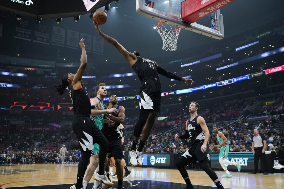 Los Angeles Clippers guard Paul George (13) grabs a rebound during the first half of an NBA basketball game against the San Antonio Spurs in Los Angeles, Thursday, Jan. 26, 2023. (AP Photo/Ashley Landis)