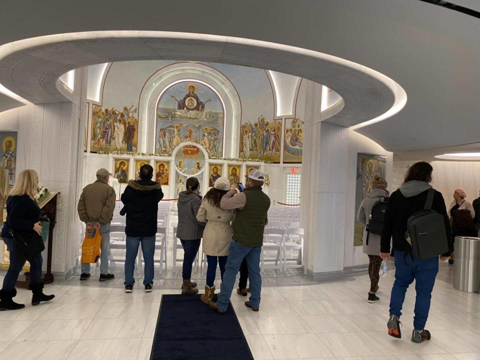 Visitors take pictures and gaze into the heart of the restored Saint Nicholas church's interior.