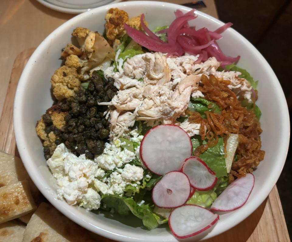 LY Salad at Lincoln Yard with rotisserie chicken, pickled red onion, capers, radishes and olives.