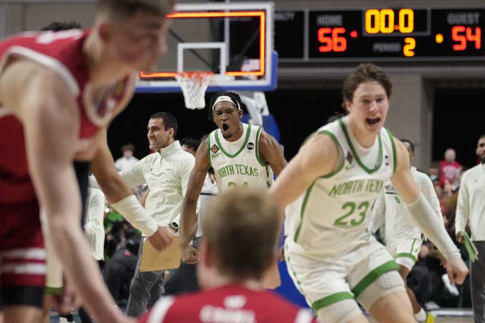 North Texas' Jayden Martinez, center, celebrates with teammates after defeating Wisconsin in an NCAA college basketball game in the semifinals of the NIT, Tuesday, March 28, 2023, in Las Vegas. (AP Photo/John Locher)