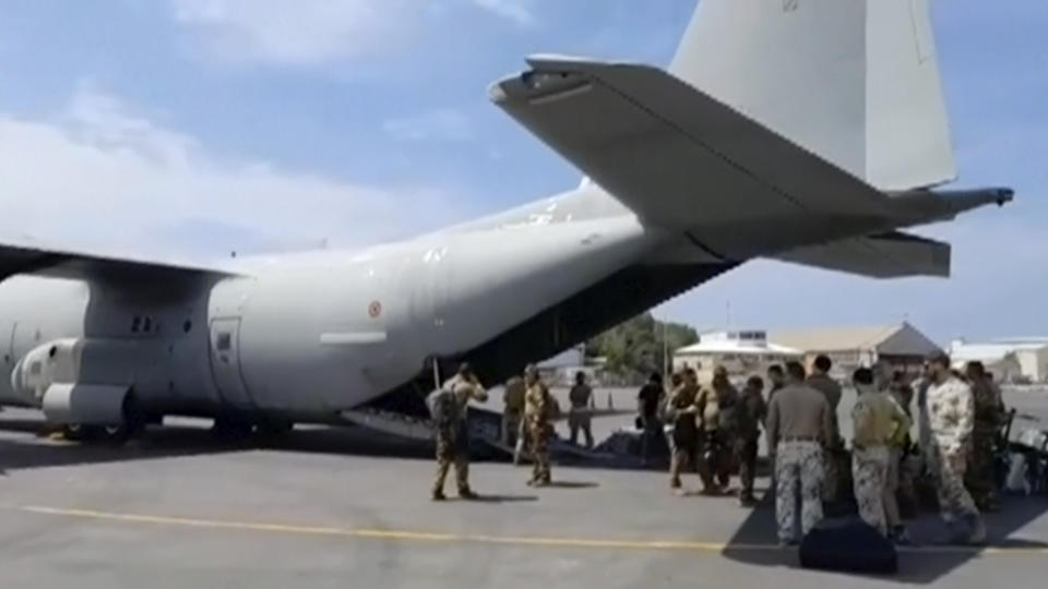 In this image from video provided by the Italian Defense Ministry, military personnel prepare to evacuate people from the airport in Khartoum, Sudan, on Sunday, April 23, 2023. Foreign nationals were flown out of the country, as forces loyal to rival generals battled for control of Africa's third-largest nation for a ninth day amid fading hopes for deescalation. (Italian Defense Ministry via AP)