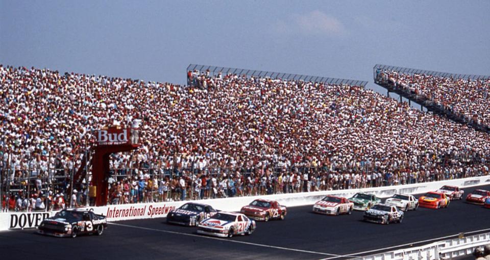 DOVER, DE - 1989: Dale Earnhardt (No. 3) leads Mark Martin (No. 6), Neil Bonnett (No. 21), Ken Schrader (No. 25), Terry Labonte (No. 11) Phil Parsons (No. 55), Ricky Rudd (No. 26), Rusty Wallace (No. 27) and Darrell Waltrip (No. 17) during a NASCAR Cup race at Dover Downs International Speedway. Earnhardt swept both Cup events at Dover during the year. (Photo by ISC Images & Archives via Getty Images)