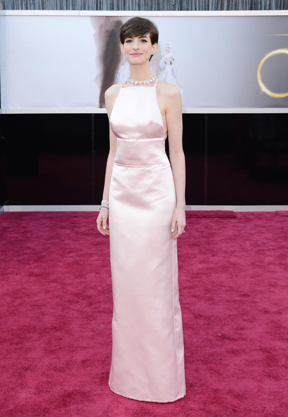 <p>Hathaway hit headlines in 2013 when she wore this pale pink Prada dress to the Oscars – and not because of how beautifully simplistic it was. The American actress was supposed to be wearing a Valentino gown but switched to the Prada at the last moment because another actress was set to wear a very similar look. Can’t say we mind: the Prada looked sensational on the petite star. </p>