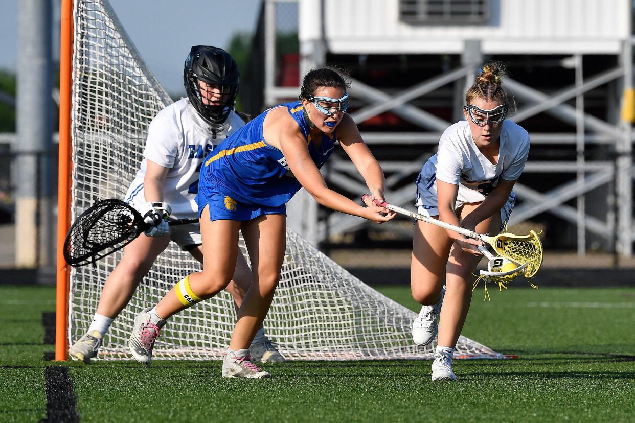 Kentucky Country Day's Dylan Yonover (19), left, and Eastern's Katherine Hagan (3) battle for possession during the first half of their Kentucky Scholastic Lacrosse League championship game, Thursday, May 16 2024 in Louisville Ky.