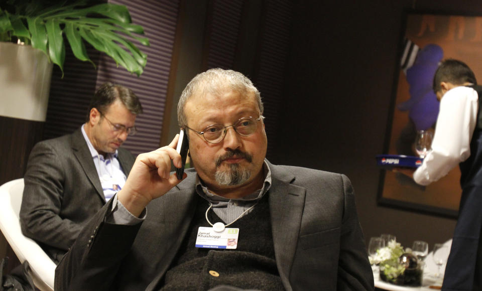 FILE - In this Jan. 29, 2011, file photo, Saudi Arabian journalist Jamal Khashoggi speaks on his cellphone at the World Economic Forum in Davos, Switzerland. The Washington Post said Wednesday, Oct. 3, 2018, it was concerned for the safety of Khashoggi, a columnist for the newspaper, after he apparently went missing after going to the Saudi Consulate in Istanbul. (AP Photo/Virginia Mayo, File)