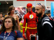 An attendee dressed as the Flash walks the convention floor at Comic-Con. REUTERS/Mike Blake